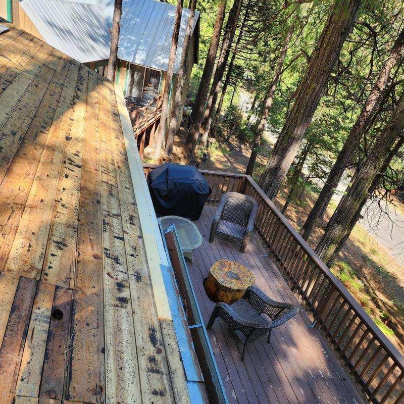 Steel seamless gutter installation on wood deck cabin