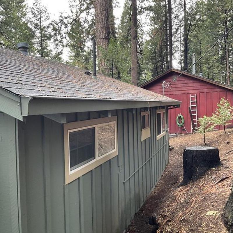 Steel seamless gutters and asphalt roof on cabin