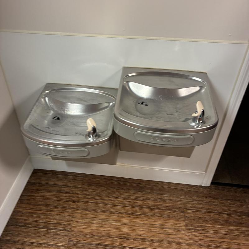 Drinking fountains with capped water and drain lines
