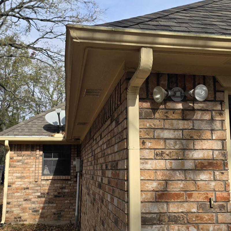 Roof gutter and downspout with brick exterior wall
