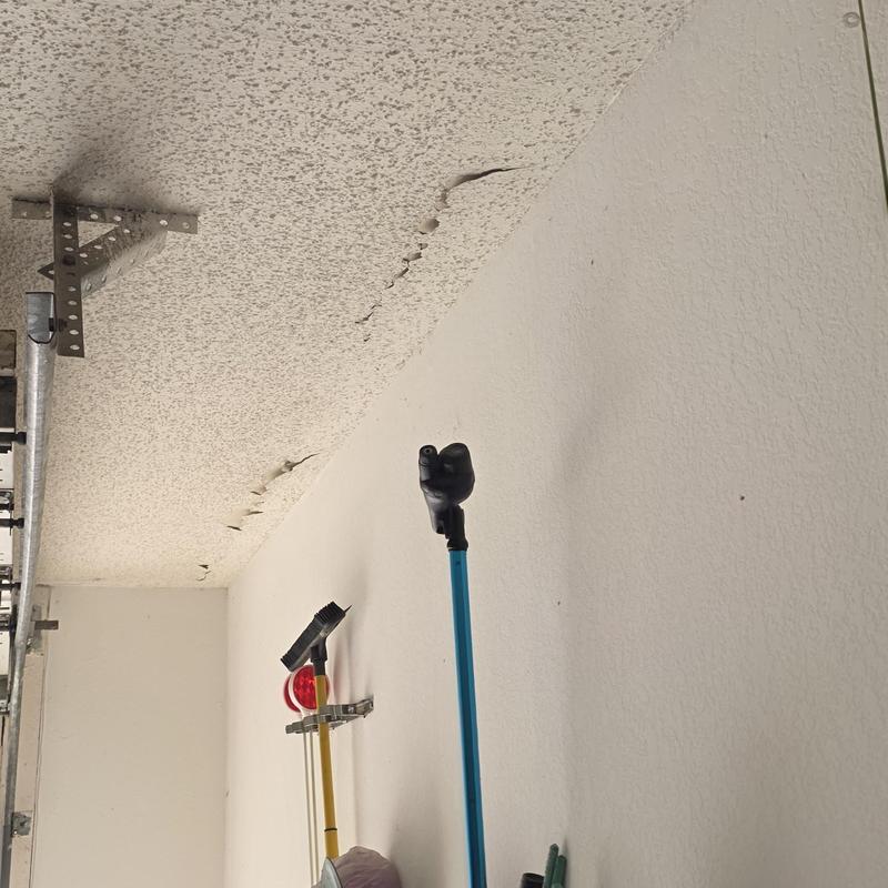 Popcorn ceiling with extensive water damage and peeling paint