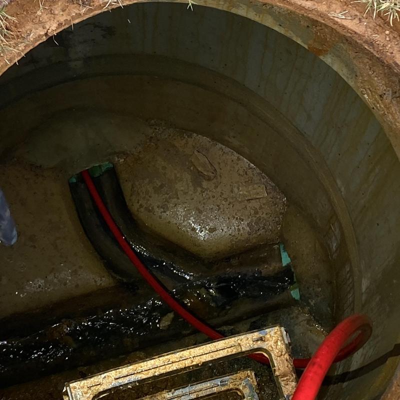 Sewer main with cable inspection in concrete manhole