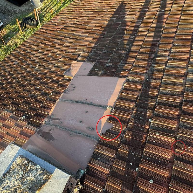 Roof tiles with storm damage circled for insurance claim