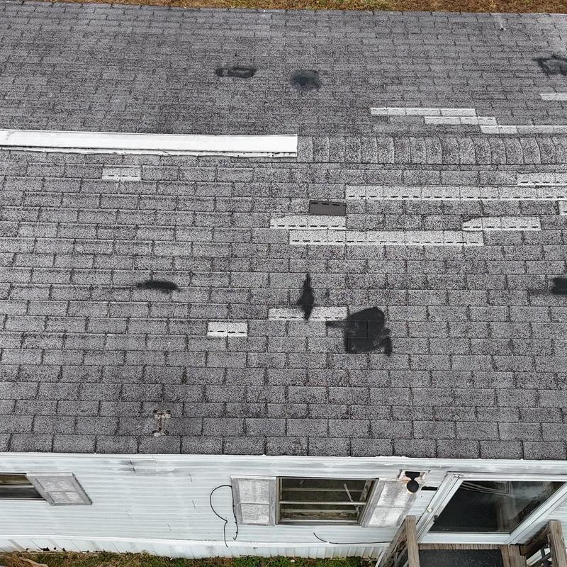 Asphalt shingle roof with marked repair areas