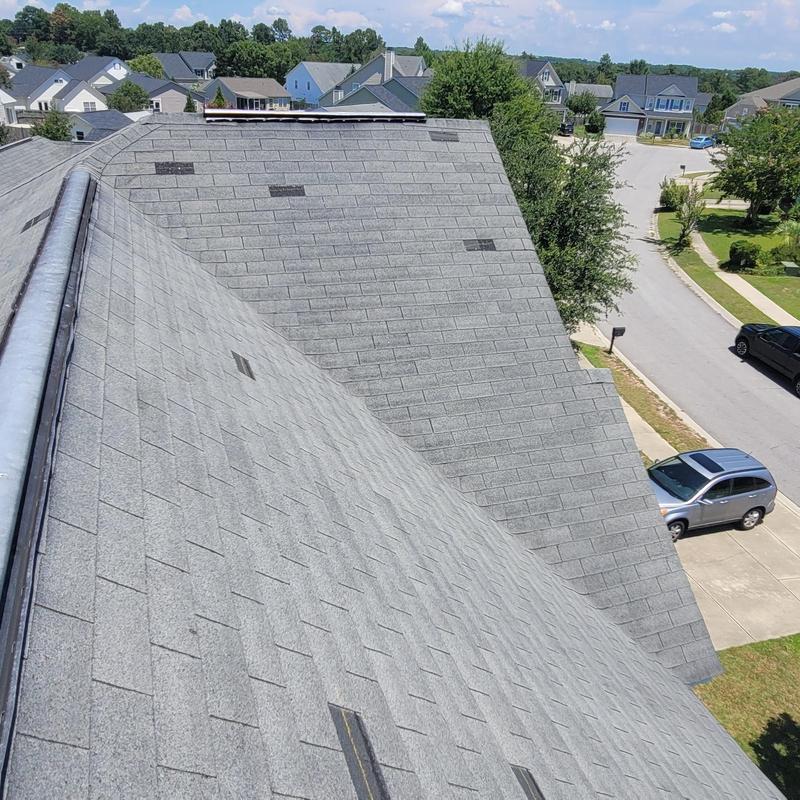 Asphalt shingle roof with storm damage patches installation