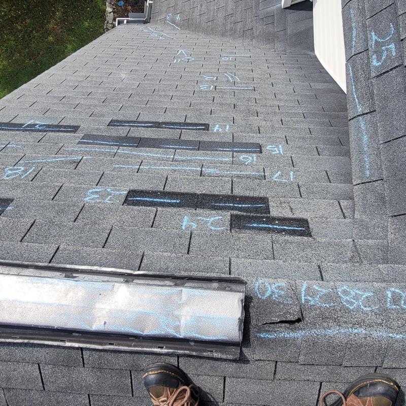 Roof shingles with chalk markings for damage assessment