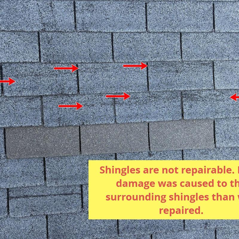 Roof shingles with impact damage marked by arrows