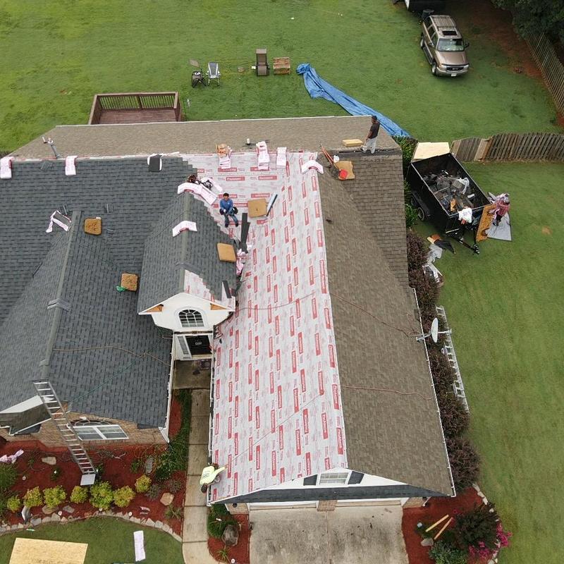 Asphalt shingle roof with underlayment installation in progress