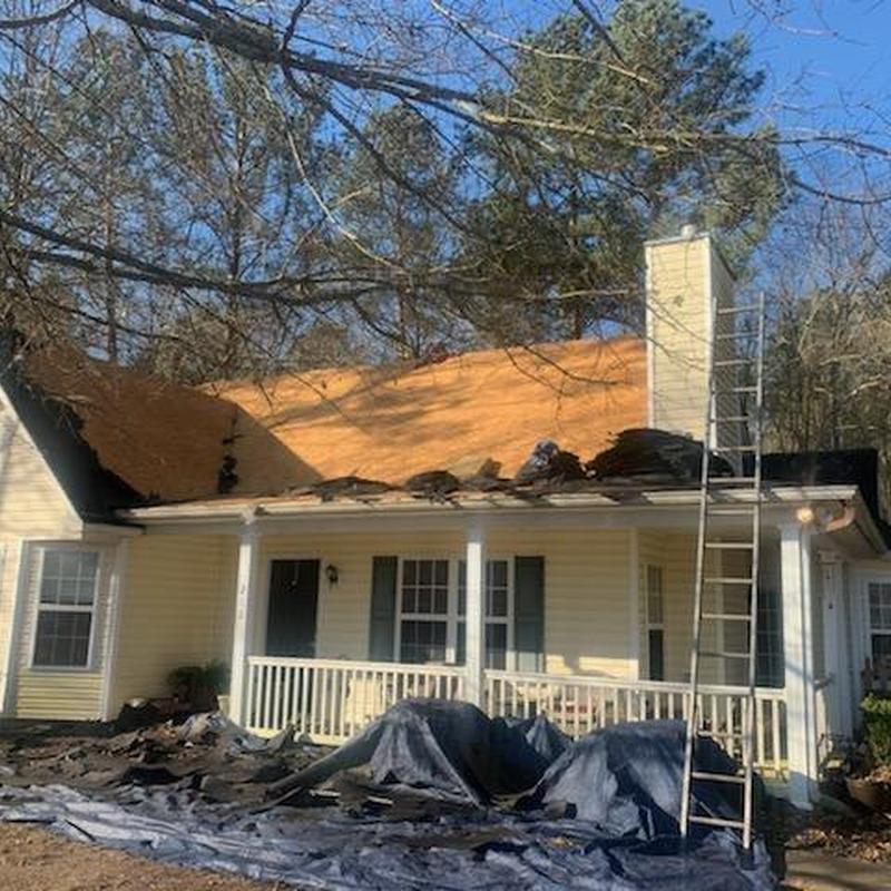 Roof sheathing replacement with debris and ladder