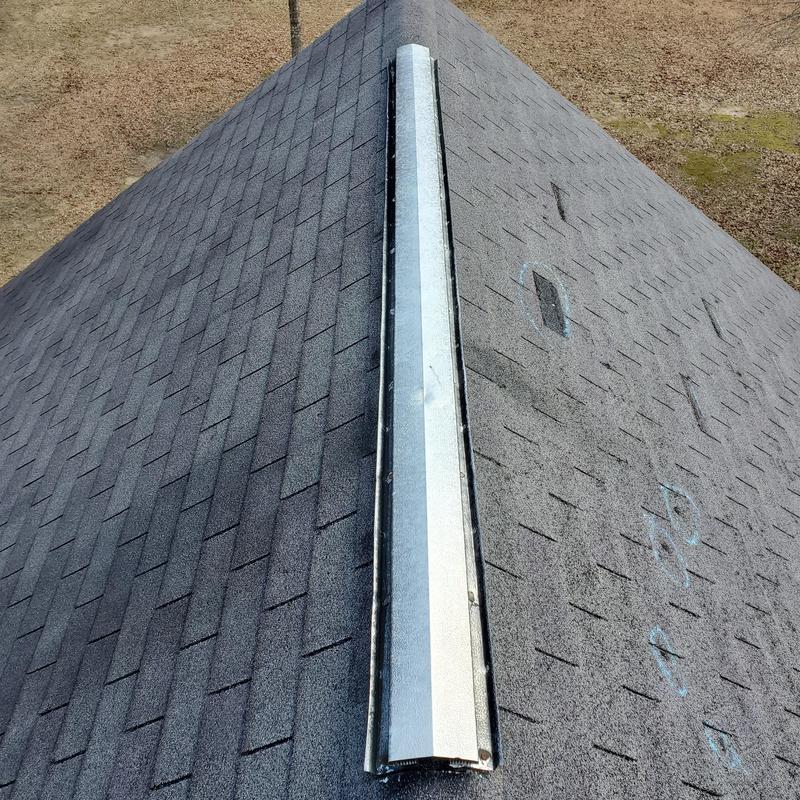 Asphalt shingle roof with marked wind damage spots