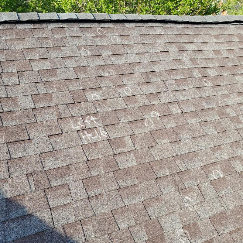 Asphalt shingle roof with hail damage inspection markings