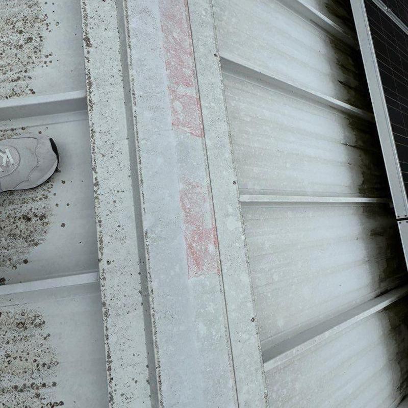 Metal roof panels with dirt and rust stains