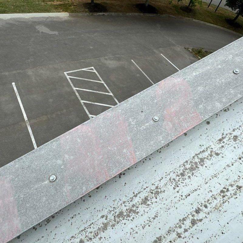Metal roof edge with hail impact marks
