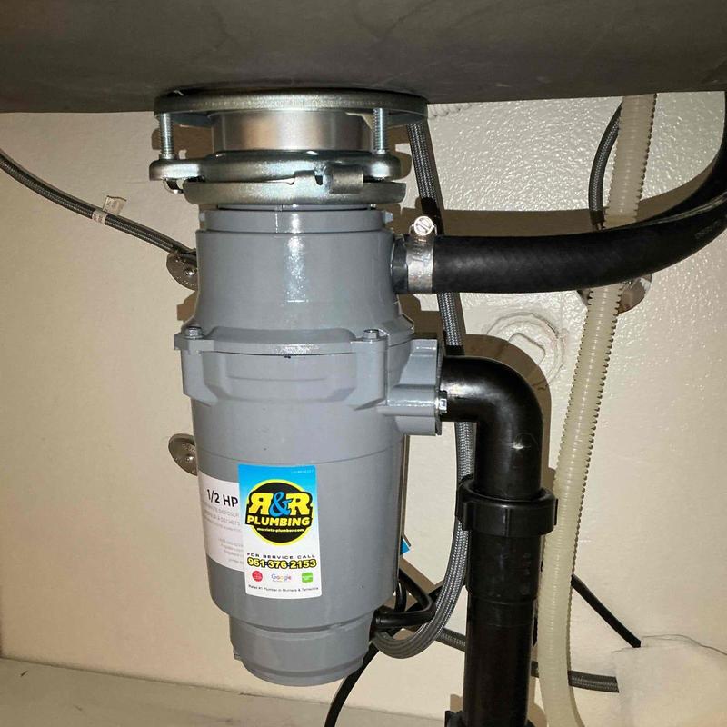 Garbage disposal unit with connected plumbing lines