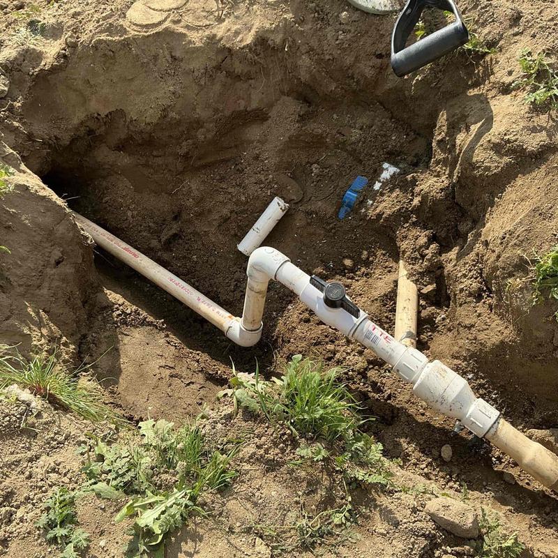 PVC ball valve and backflow preventer installation in trench