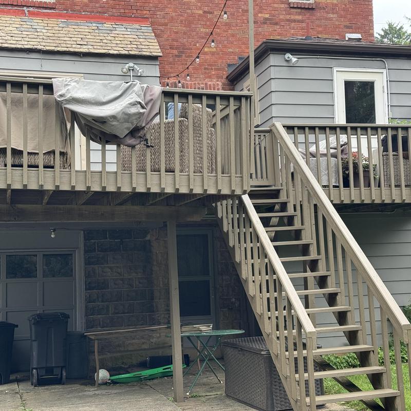 Wooden exterior deck and staircase with railing