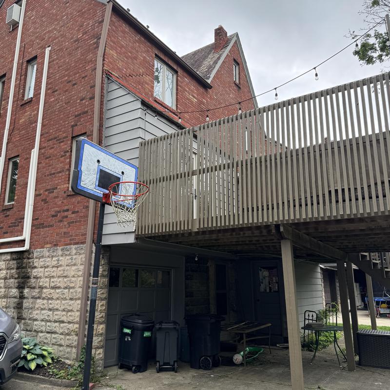 Basketball hoop mounted near residential deck