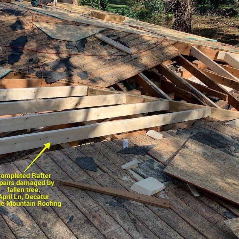 Roof rafters with new wood repairs after tree damage Roof rafters with new wood repairs after tree damage