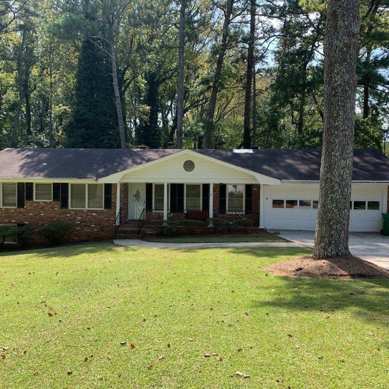 Asphalt shingle roof and gutters on brick house Asphalt shingle roof and gutters on brick house