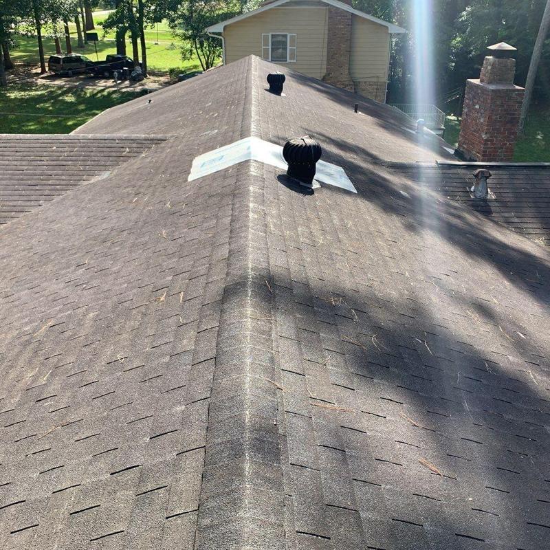 Asphalt shingle roof with ridge vent and ventilation turbines Asphalt shingle roof with ridge vent and ventilation turbines