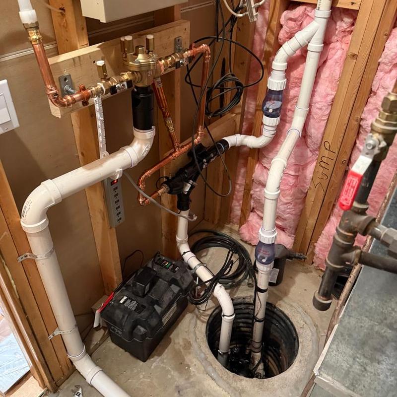 City water-powered backup sump pump with backflow prevention