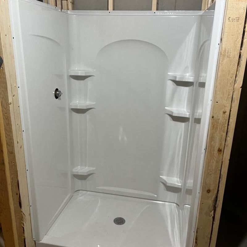 Shower stall installation with built-in shelves in framing