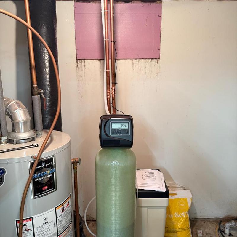 Clack water softener system installation in basement
