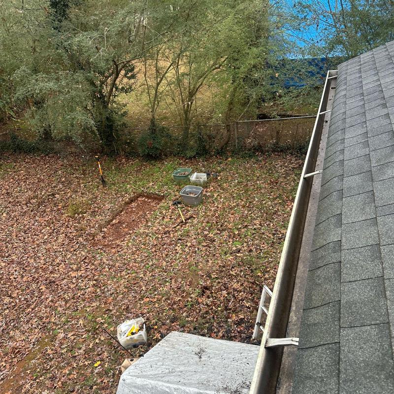 Roof gutter cleaning with tools and bins in yard Roof gutter cleaning with tools and bins in yard