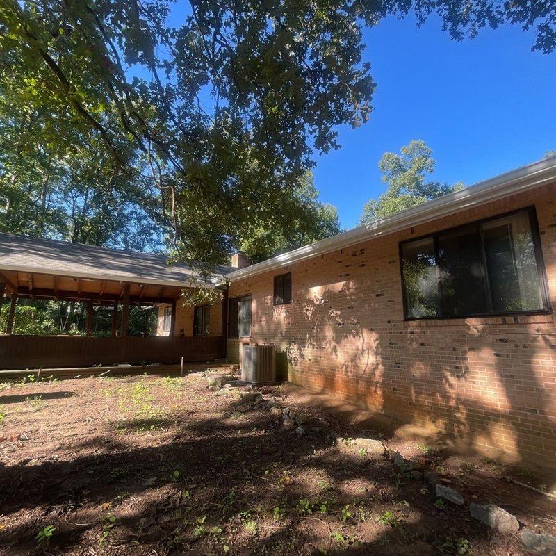 Seamless gutters installation on brick house exterior Seamless gutters installation on brick house exterior
