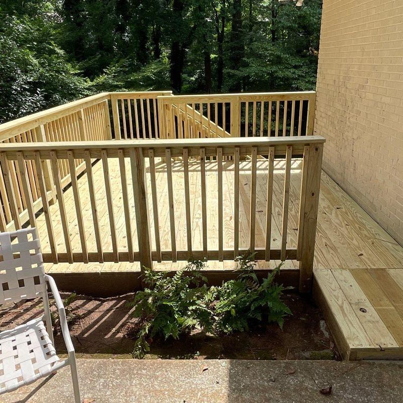 Wooden deck with custom-built stairs and railing Wooden deck with custom-built stairs and railing