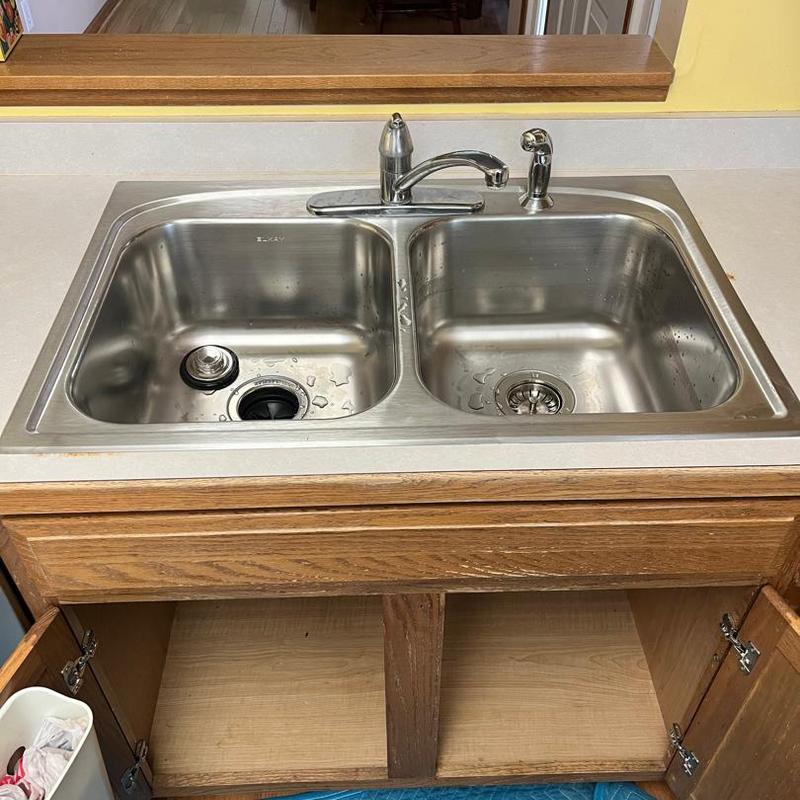 Double stainless steel kitchen sink with faucet installed