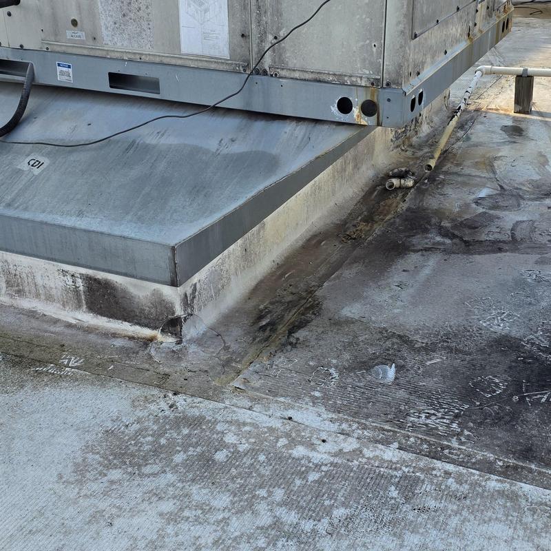 Rooftop HVAC unit base with water damage and debris Rooftop HVAC unit base with water damage and debris