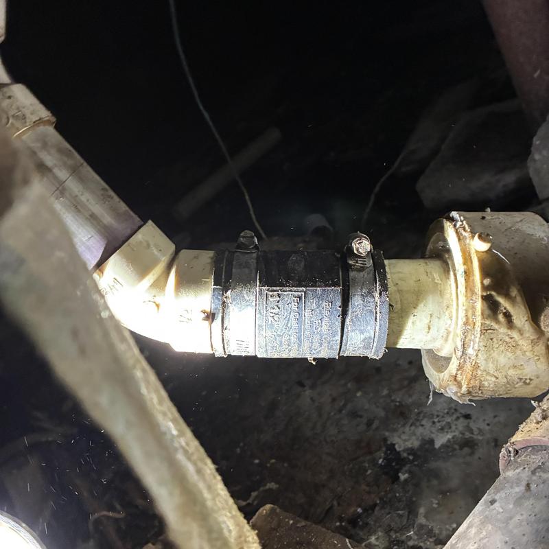 Drain pipe with rubber coupling in crawlspace repair