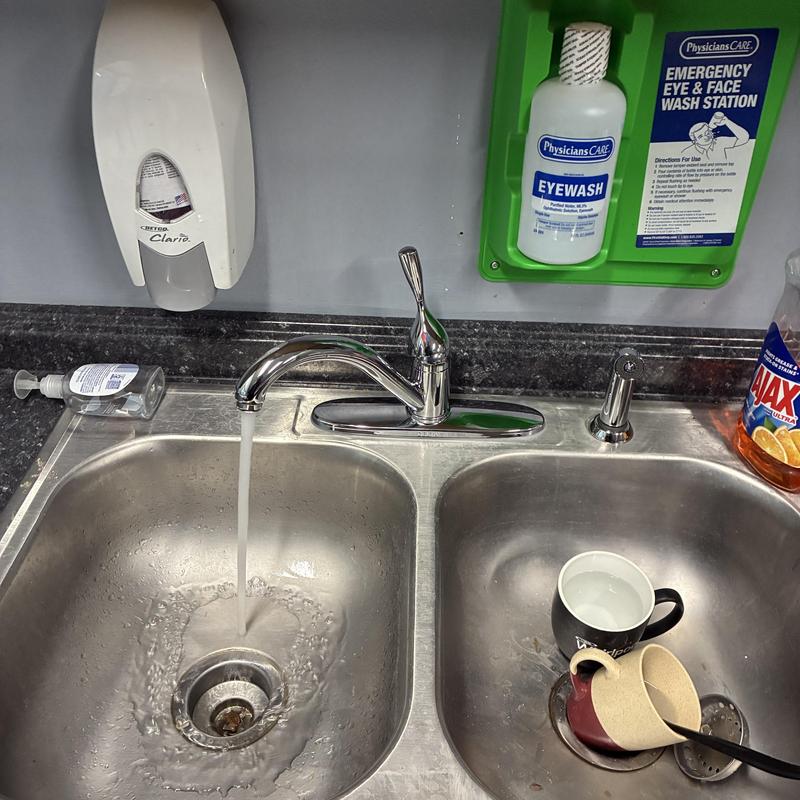 Break room faucet with running water and soap dispenser