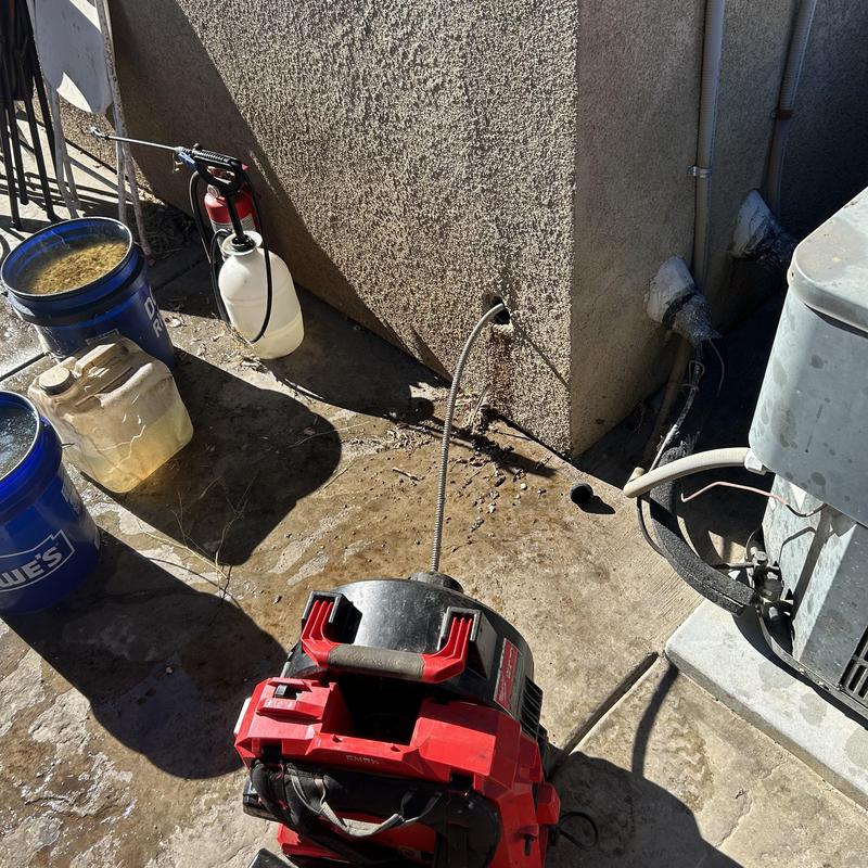 Kitchen sink drain cleaning machine clearing clog