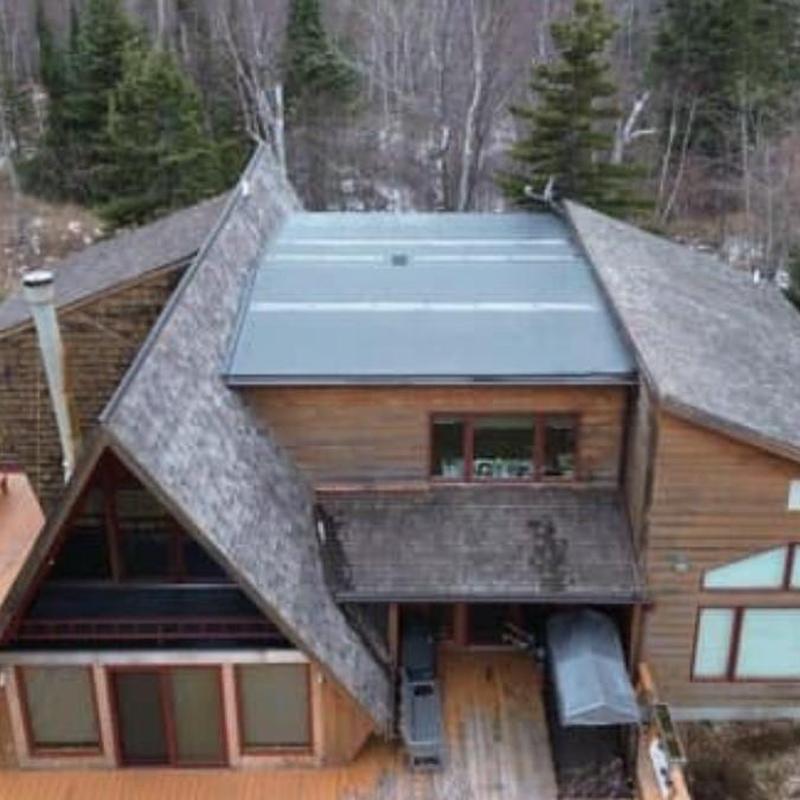 Metal roof section on wood house with snow risks Metal roof section on wood house with snow risks