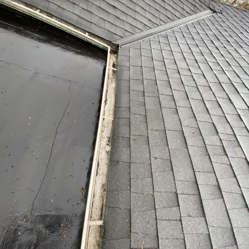 Gutter system with shingle roof intersection and debris
