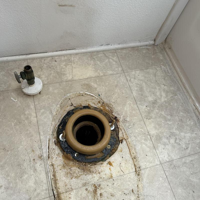 Toilet flange and wax ring on tiled floor before installation