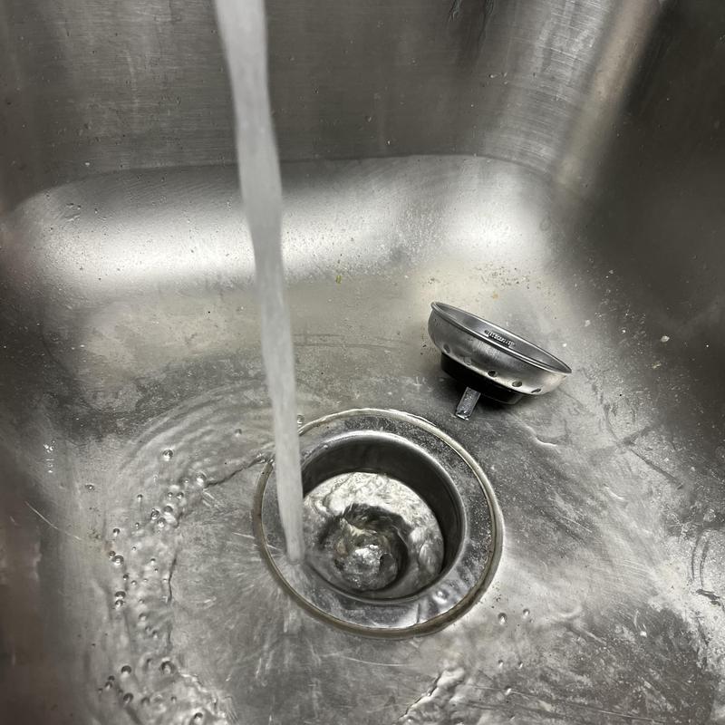 Kitchen sink drain with running water and removed strainer