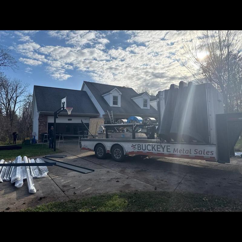 Standing seam aluminum roof materials on trailer in driveway Standing seam aluminum roof materials on trailer in driveway