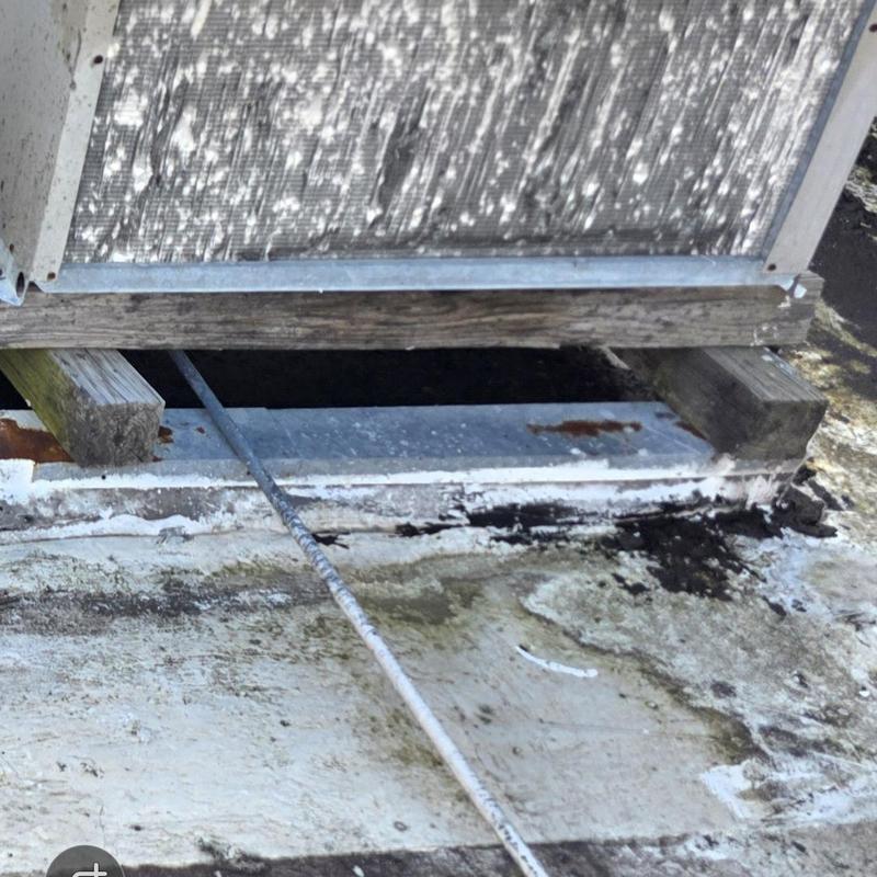 HVAC condenser base with wood and rust damage HVAC condenser base with wood and rust damage