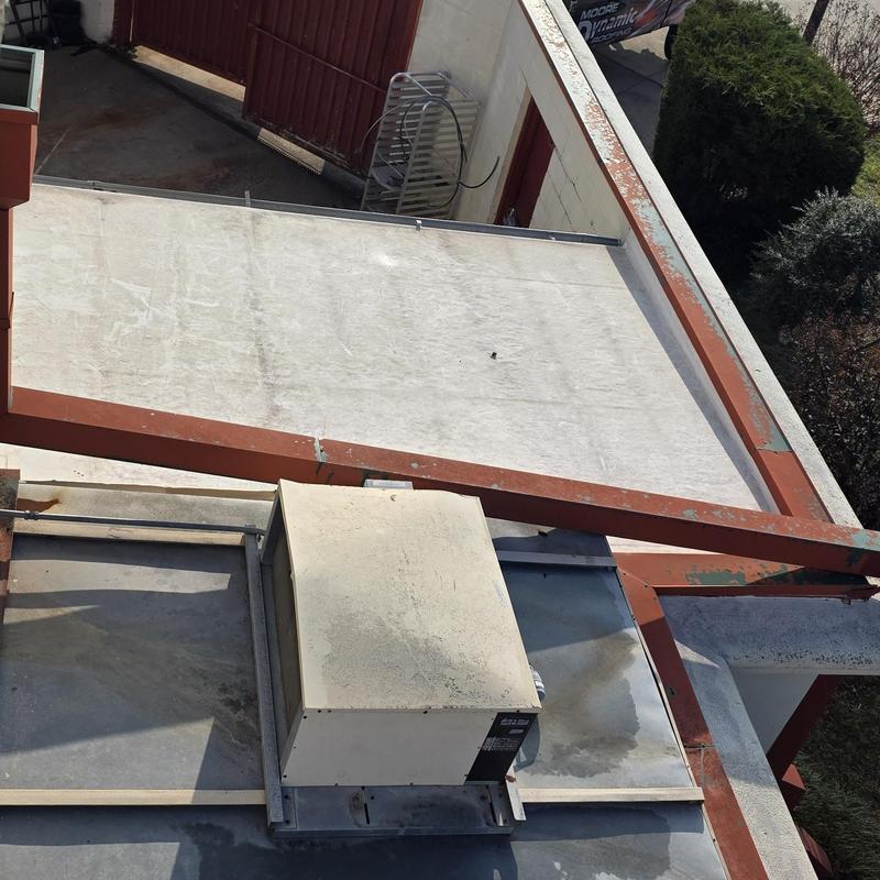 Flat roof and rooftop HVAC unit on commercial building Flat roof and rooftop HVAC unit on commercial building