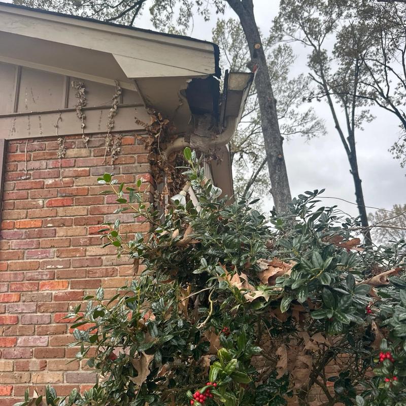 Soffit and fascia damage near gutter on brick house