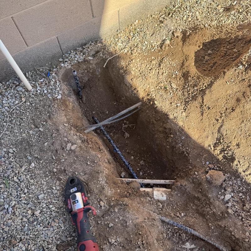 Gas line installation trench with pipes and tool