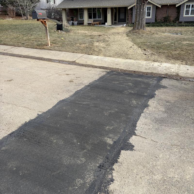 Sewer line asphalt patch on residential street Sewer line asphalt patch on residential street