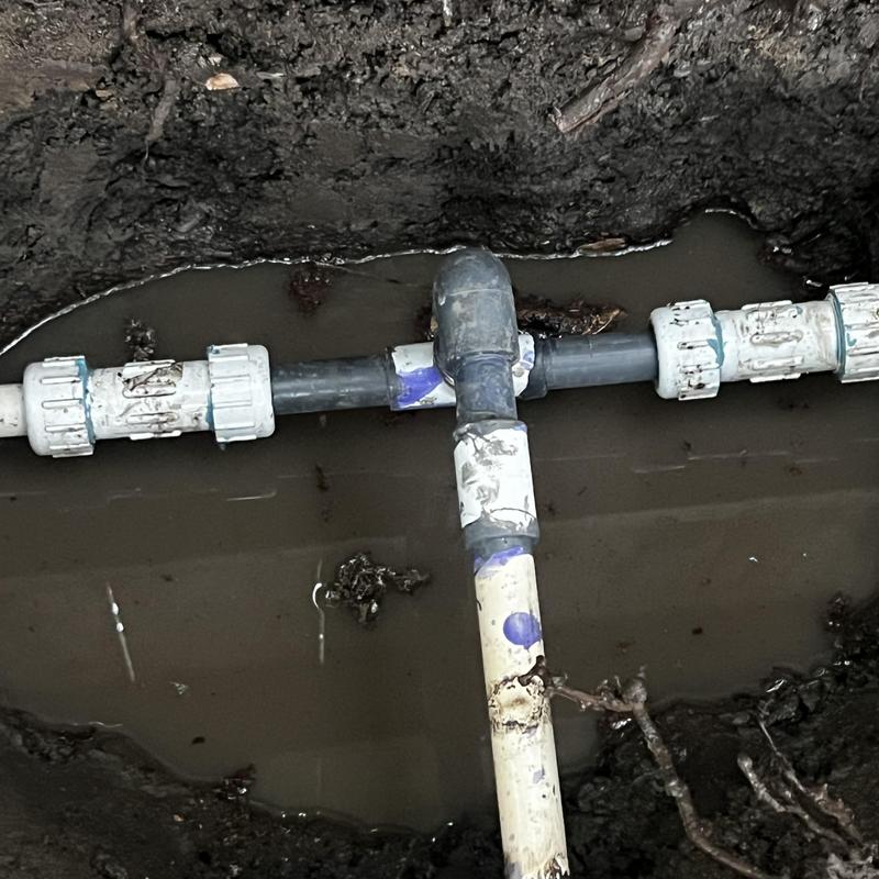 PVC tee fitting with underground water leak repair