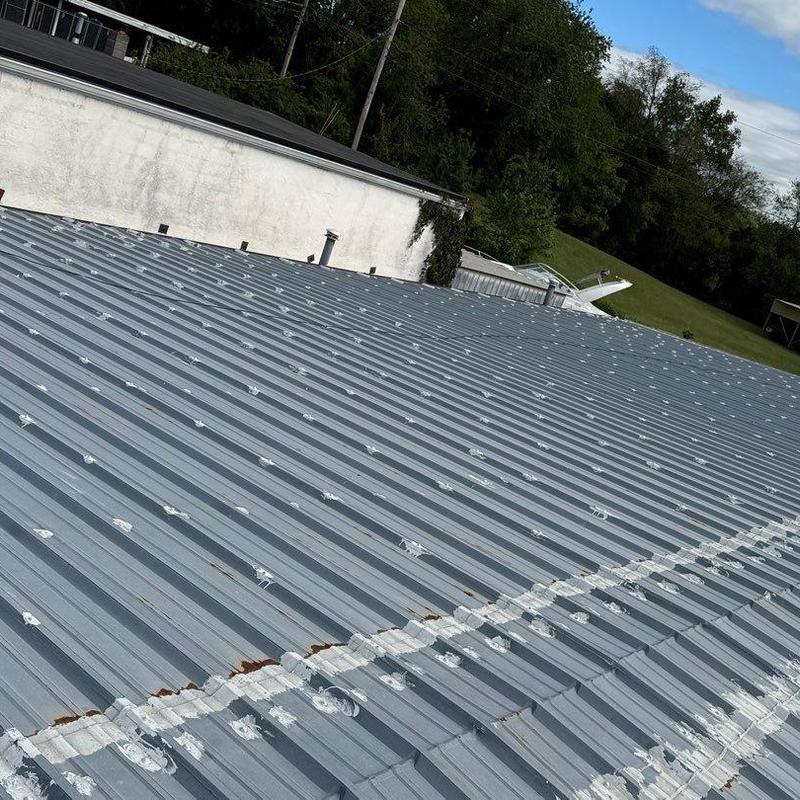 Metal roof hail damage with rust spots visible