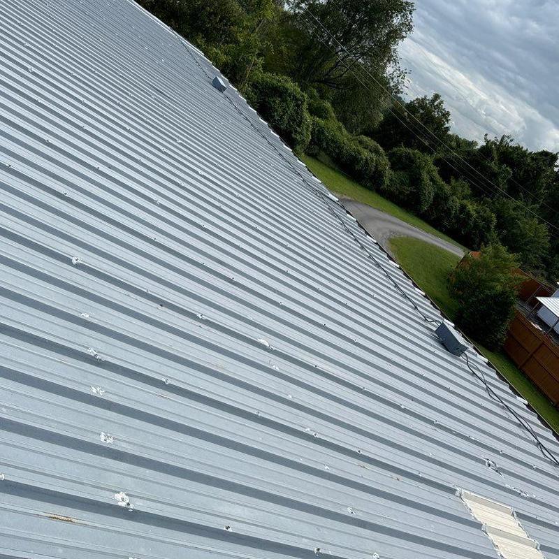 Metal roof with hail impact damage and repairs