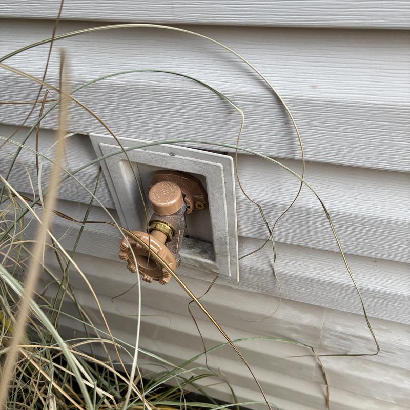 Hose faucet mounted on exterior vinyl siding