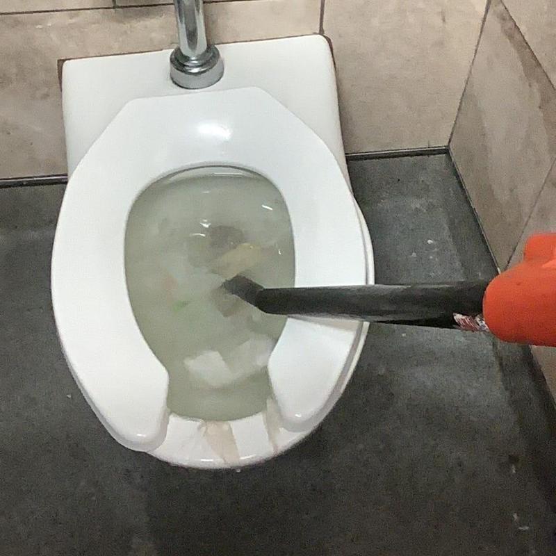Toilet drain clearing with plumbing snake tool